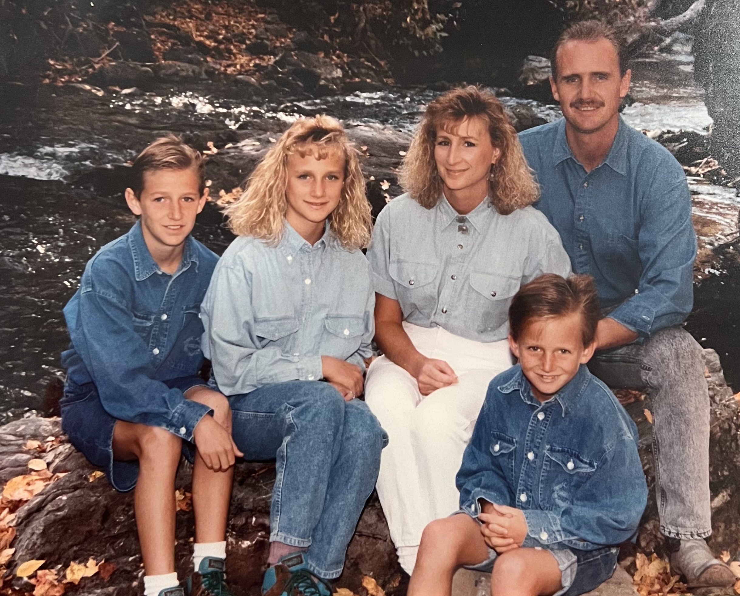 The Hirsts by a creek — denim everything, ~1990s.
